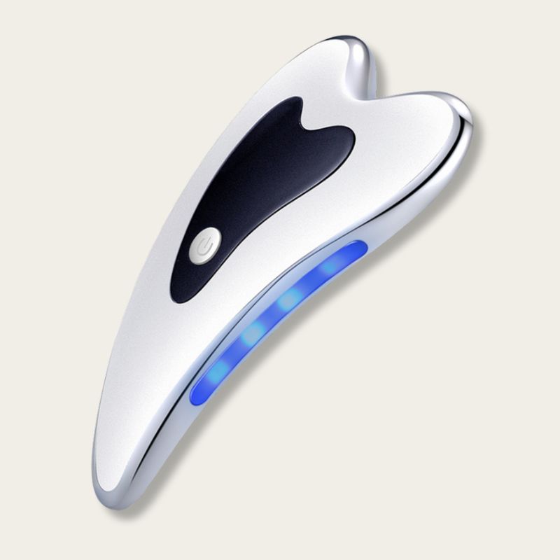Appareil Gua Sha électrique vue de face, lumière bleue activée pour soin du visage